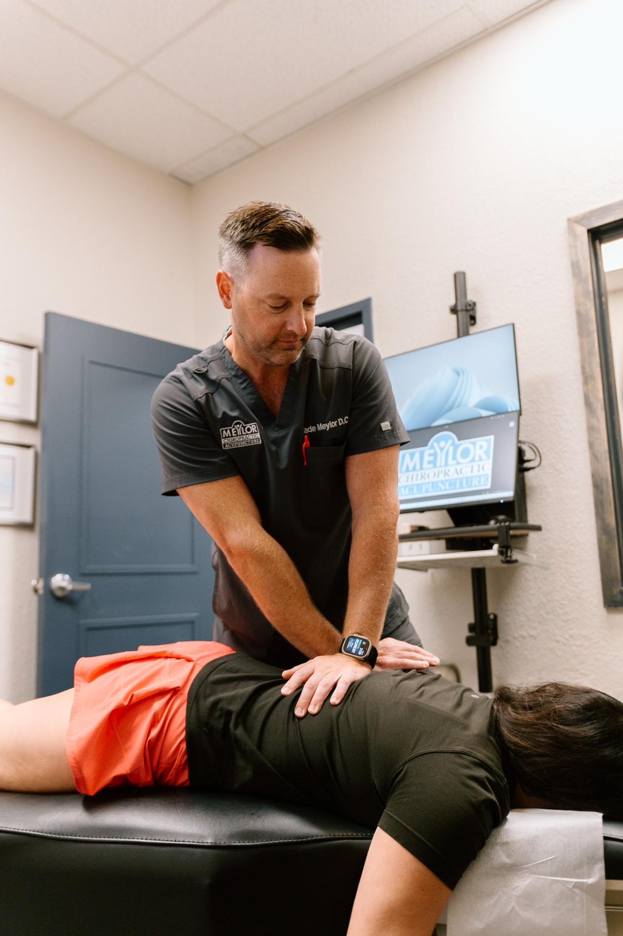 Lenexa chiropractor Dr. Meylor performing spinal adjustment for back pain relief
