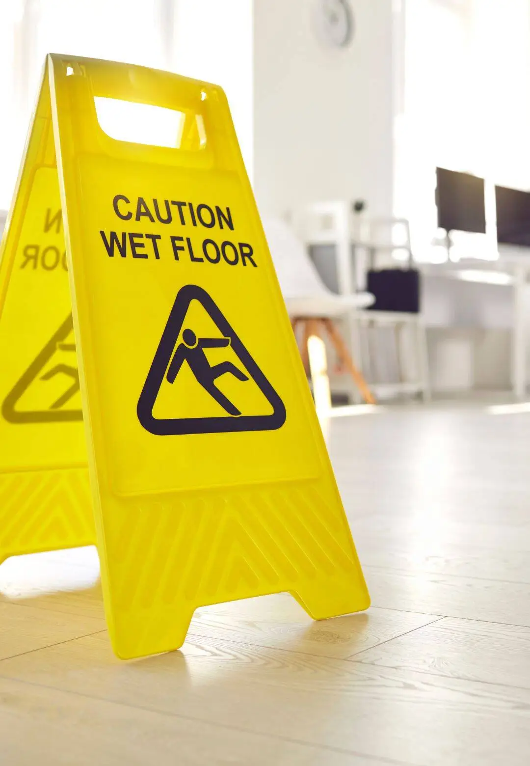 Workplace safety caution sign on wet floor