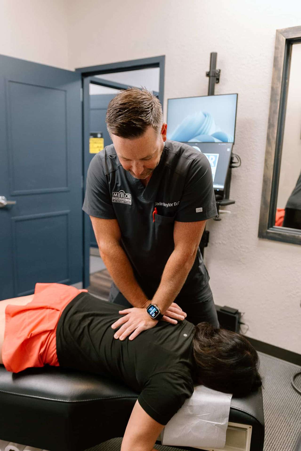 Lenexa chiropractor Dr. Meylor performing spinal adjustment for comprehensive chiropractic care